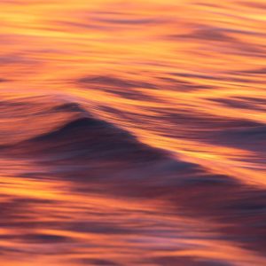 Fire & Water II - an abstract image of sunset reflected on the waves of the ocean
