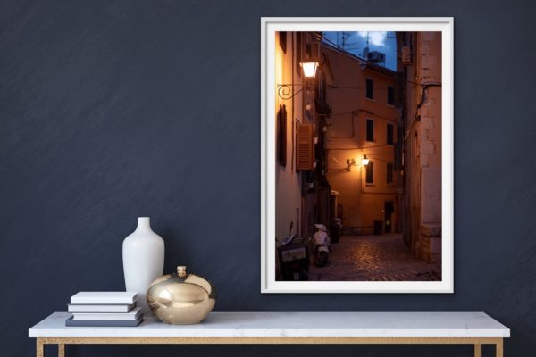 Old town - a night time street scene in the old town of Rovinj, Croatia. Framed in white