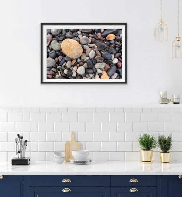 An abstract photo of pebbles. Framed in black