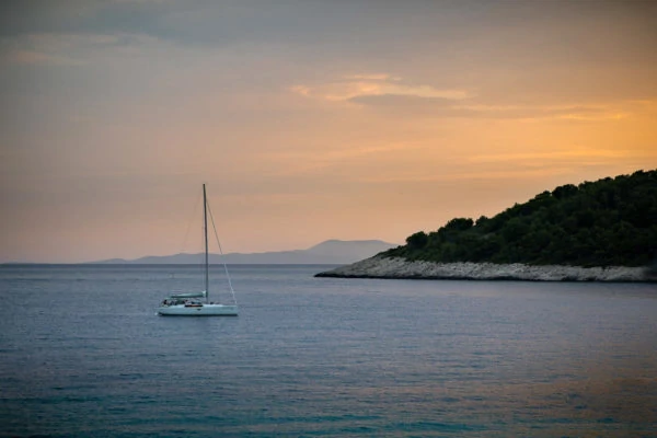 Sunset sailing - a yacht at sunset off the coast of Hvar in Croatia.