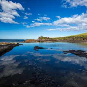 The blue sky reflecting in the water of Gerringong's Boat Harbour