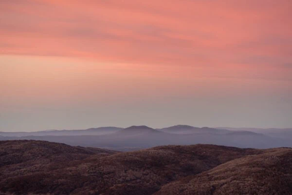 Alps Sunrise - A soft alpine sunrise dusts the rolling peaks of Kosciuszko National Park, Australia