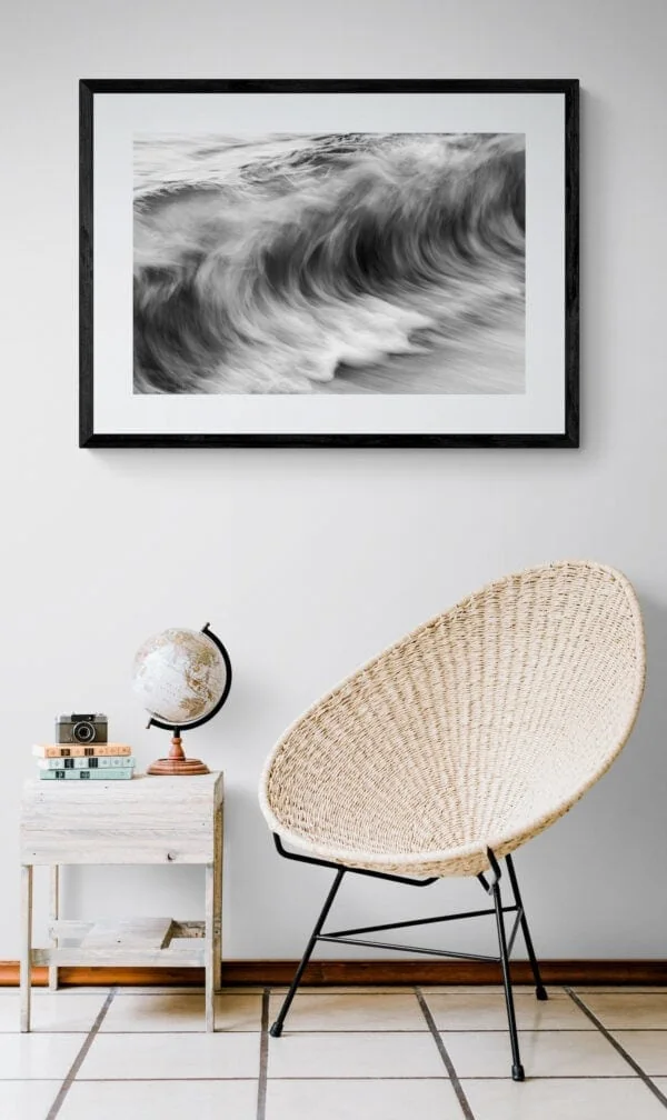 The ocean’s movement - textures resembling charcoal sketches. Framed in black