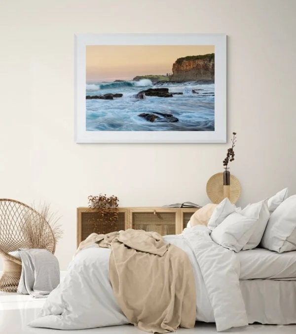Surging ocean waters and headlands at sunset. Framed in white