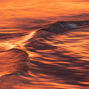 Fire Water I - A fiery sunrise colours the already fascinating textures of the waves. South Coast, Australia