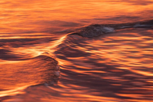 Fire Water I - A fiery sunrise colours the already fascinating textures of the waves. South Coast, Australia